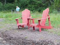 Two Red Adirondack Chairs