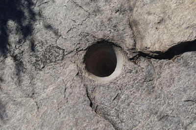 hole in rock where grains were ground