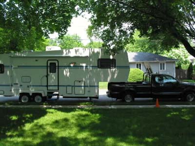 Our truck
            and trailer in fron to our house in 2002