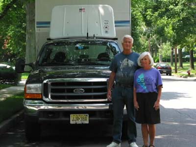 Debby and Charlie in fron to
            our truck at our NJ house in 2002